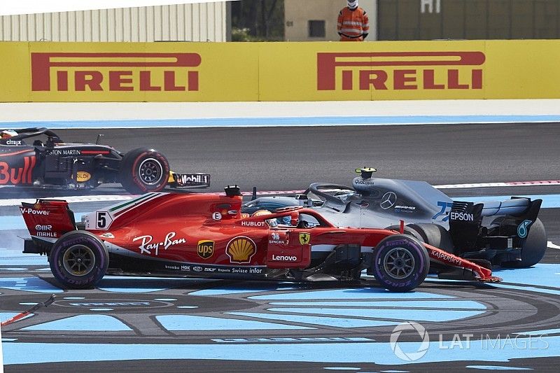 Sebastian Vettel, Ferrari SF71H, and Valtteri Bottas, Mercedes AMG F1 W09, spin to the back after contact on the opening lap