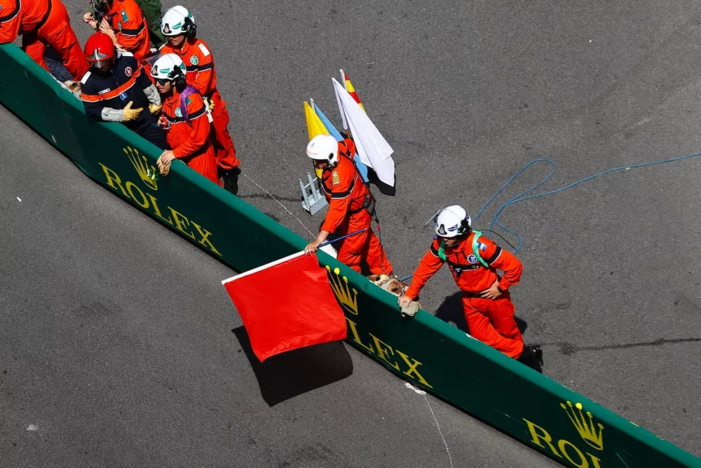 Marshals wave the red flags after an opening lap crash
