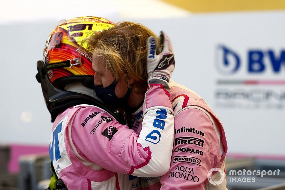 Sergio Perez, Racing Point, comiserates with his mechanics after retiring from the race