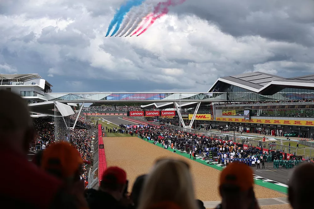 The Red Arrows fly over the grid at Silverstone