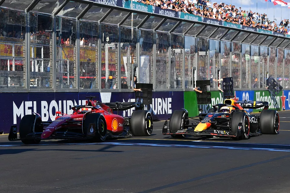 Charles Leclerc, Ferrari F1-75, battles with Max Verstappen, Red Bull Racing RB18, at the restart
