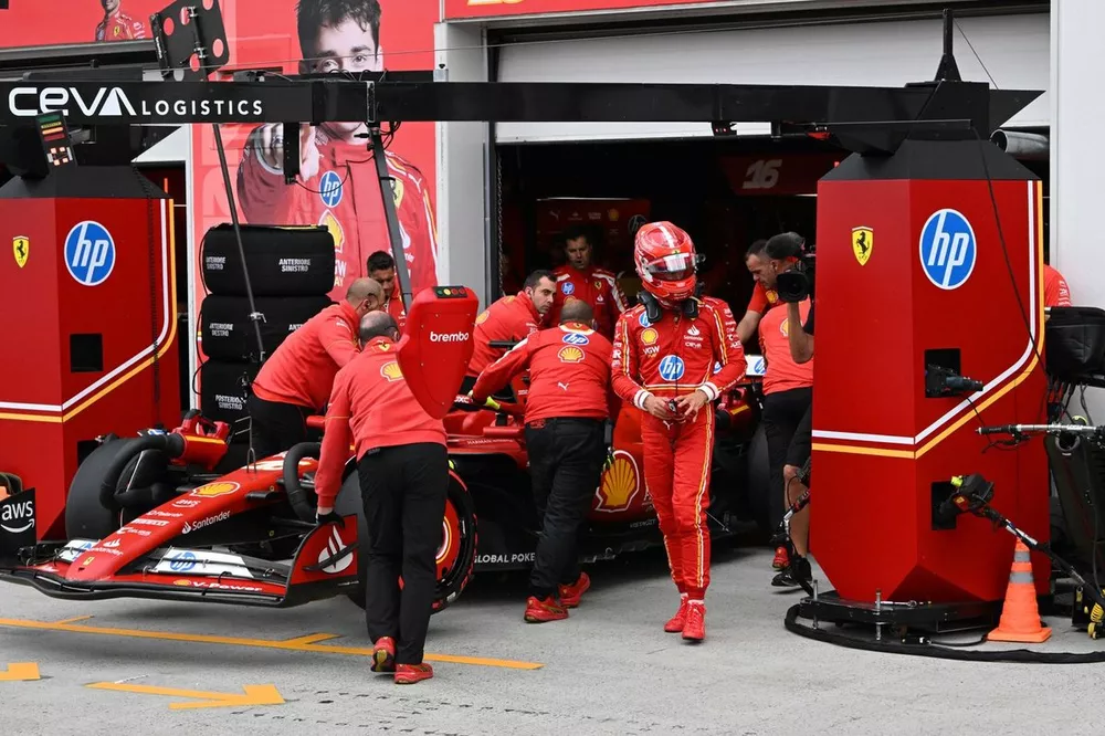Charles Leclerc, Scuderia Ferrari, walks down the pit lane