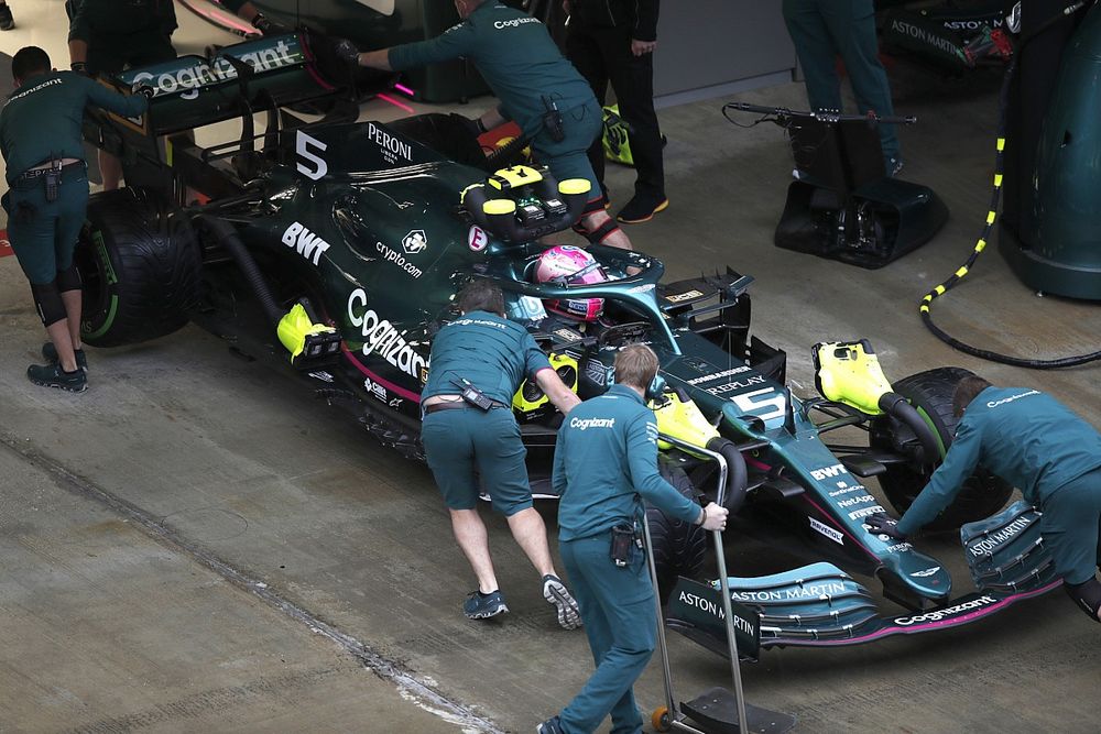 Sebastian Vettel, Aston Martin AMR21, is returned to the garage