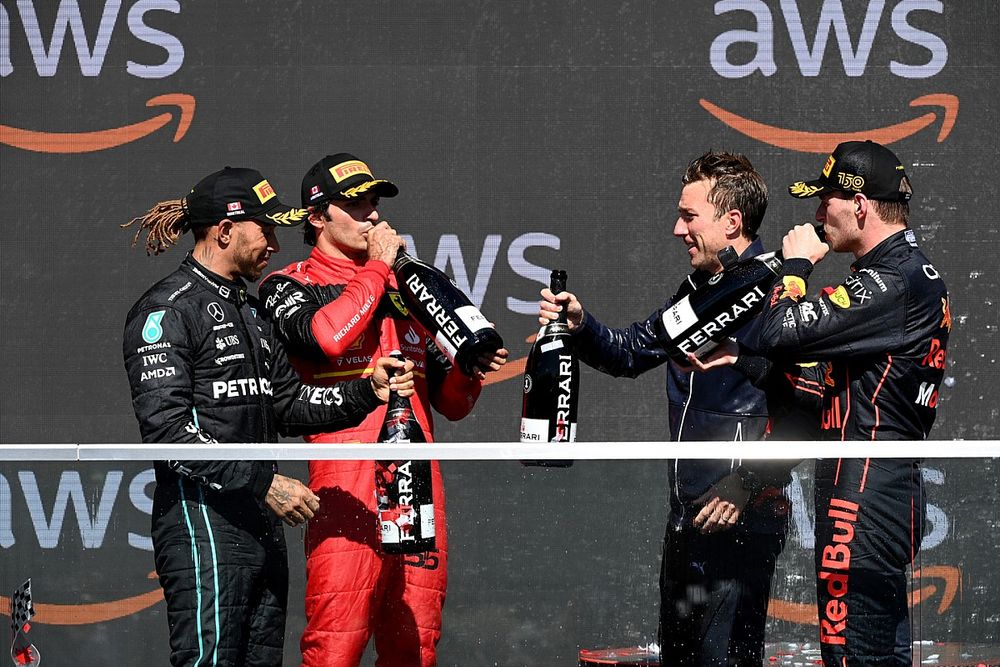 Lewis Hamilton, Mercedes-AMG, 3rd position, Carlos Sainz, Ferrari, 2nd position, the Red Bull trophy delegate and Max Verstappen, Red Bull Racing, 1st position, on the podium