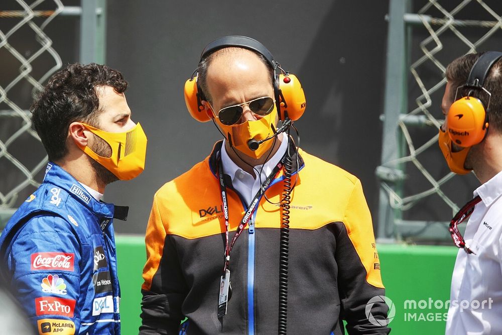 Daniel Ricciardo, McLaren, on the grid with an engineer