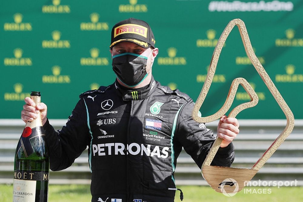 Valtteri Bottas, Mercedes-AMG Petronas F1, celebrates with his champagne and trophy on the podium