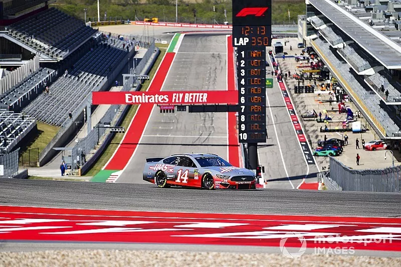Romain Grosjean, Haas F1 Team, and Kevin Magnussen, Haas F1 Team, ride with Tony Stewart