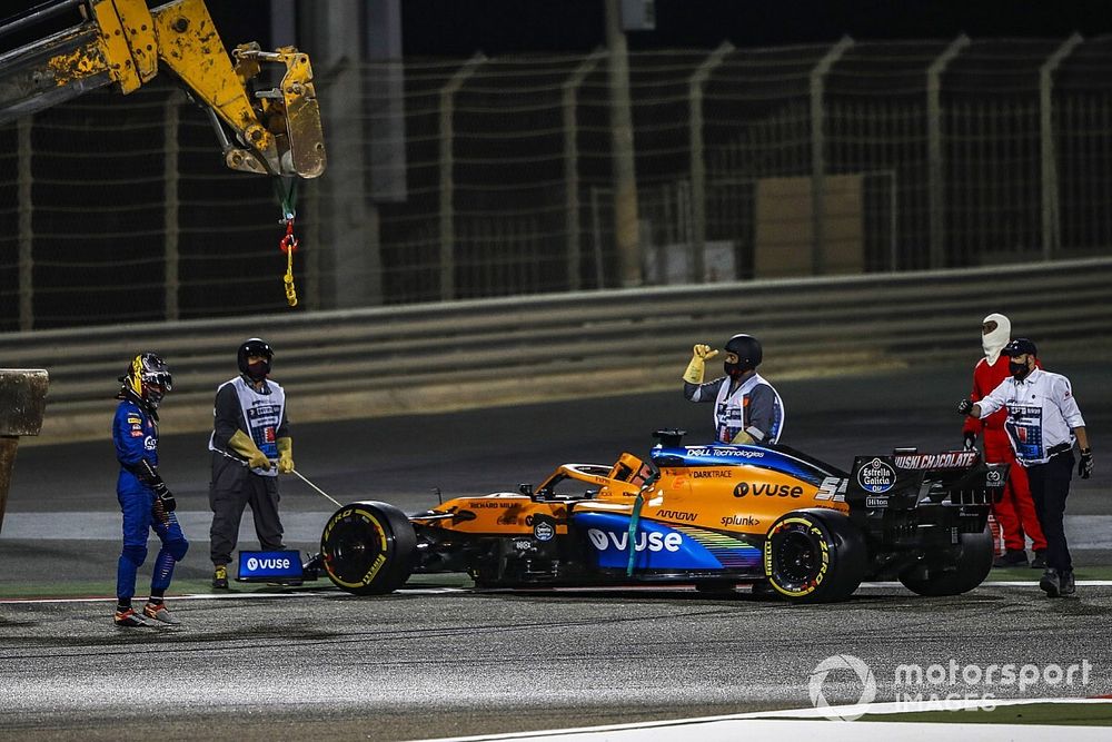 Marshals remove the car of Carlos Sainz Jr., McLaren MCL35, after he stopped with mechanical issues