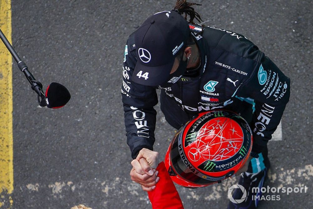 Mick Schumacher, Alfa Romeo Racing, presents race winner Lewis Hamilton, Mercedes-AMG F1, with the Mercedes helmet of his father, Michael Schumacher, from 2012