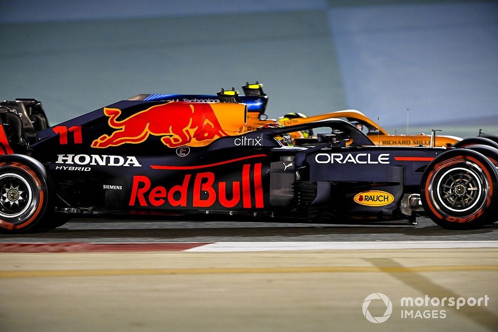 Sergio Perez, Red Bull Racing RB16B, passes Lando Norris, McLaren MCL35M