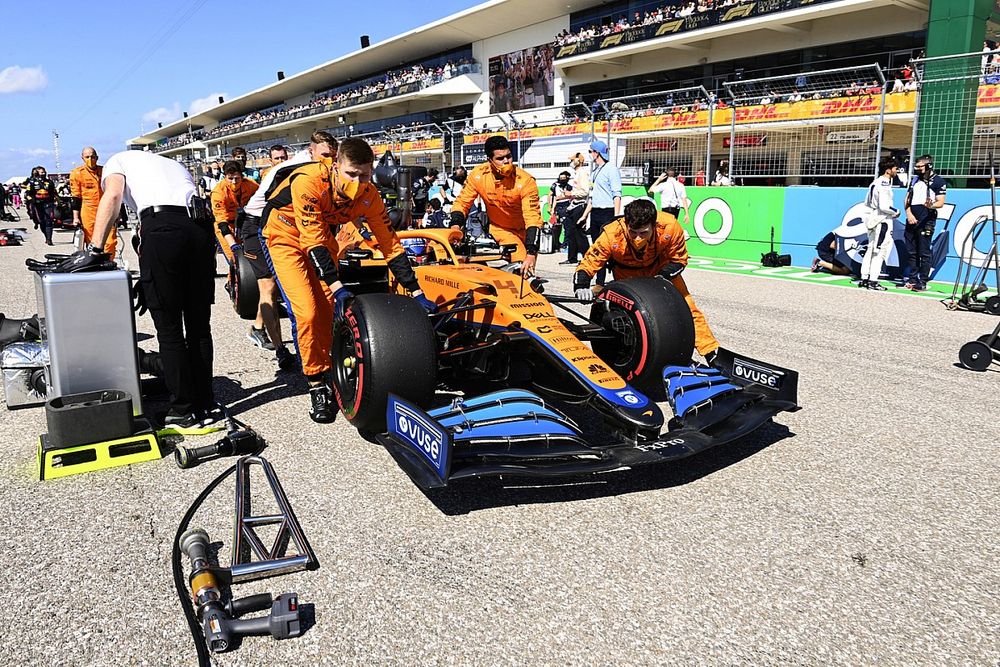 Lando Norris, McLaren MCL35M, arrives on the grid with mechanics