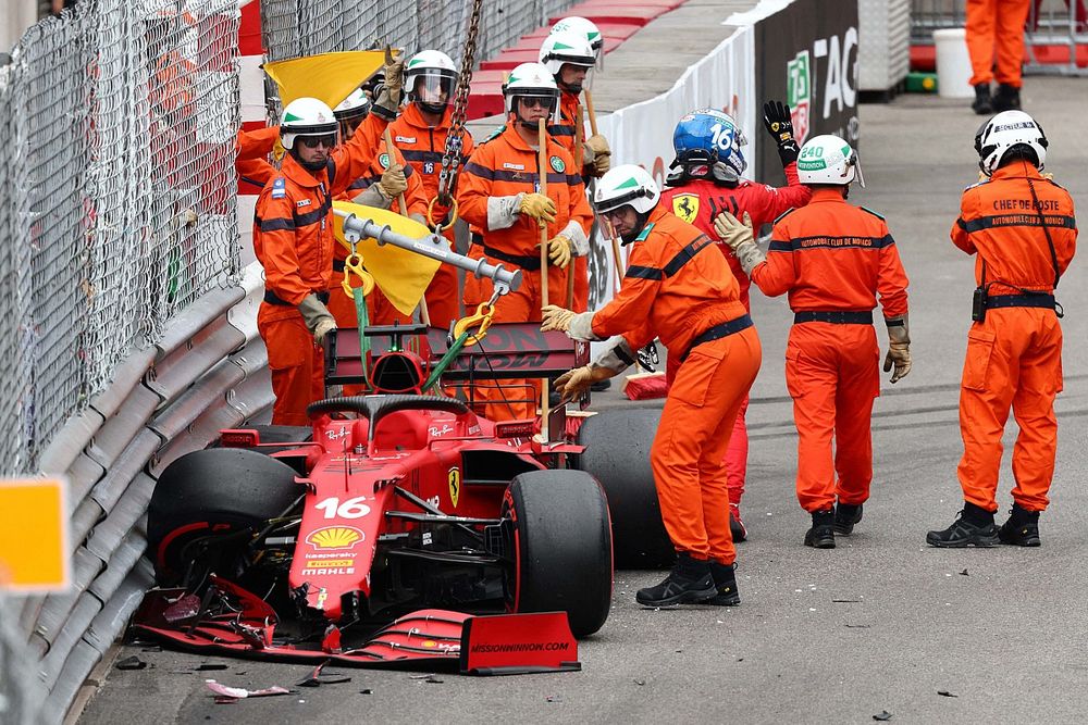 Marshals assist Charles Leclerc, Ferrari SF21, after he crashes out of Qualifying