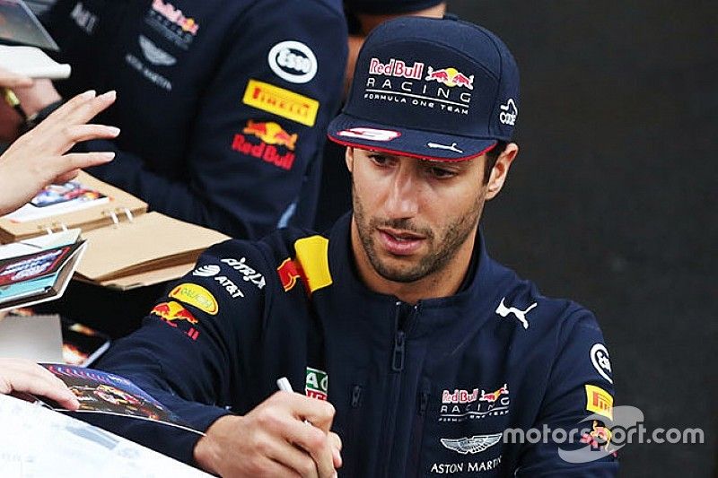 Daniel Ricciardo, Red Bull Racing, and Max Verstappen, Red Bull, sign autographs for fans