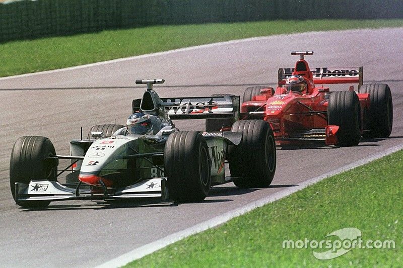 Mika Hakkinen, McLaren MP4/13 leads Michael Schumacher, Ferrari F300