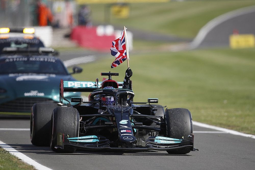 Lewis Hamilton, Mercedes W12, 1st position, flies a Union flag from his cockpit in celebration on his way to Parc Ferme