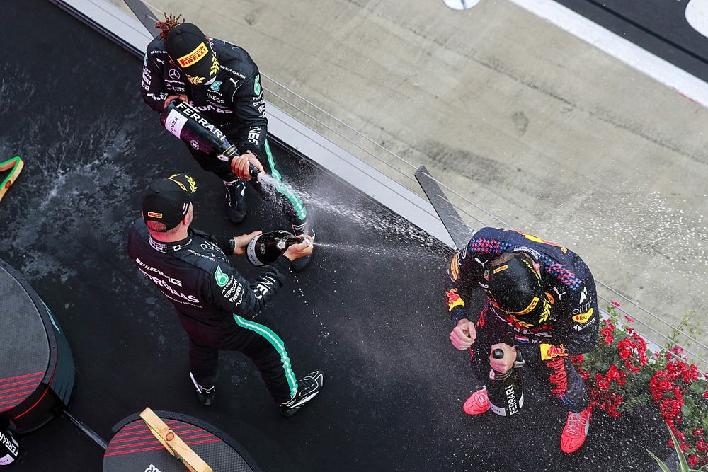 Valtteri Bottas, Mercedes, 3rd position, Lewis Hamilton, Mercedes, 2nd position, and Max Verstappen, Red Bull Racing, 1st position, celebrate with Champagne on the podium