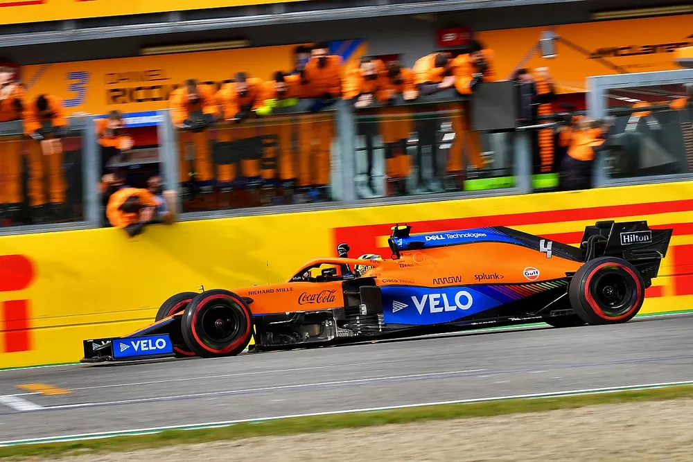 Lando Norris, McLaren MCL35M, 3rd position, crosses the line to cheers from his team
