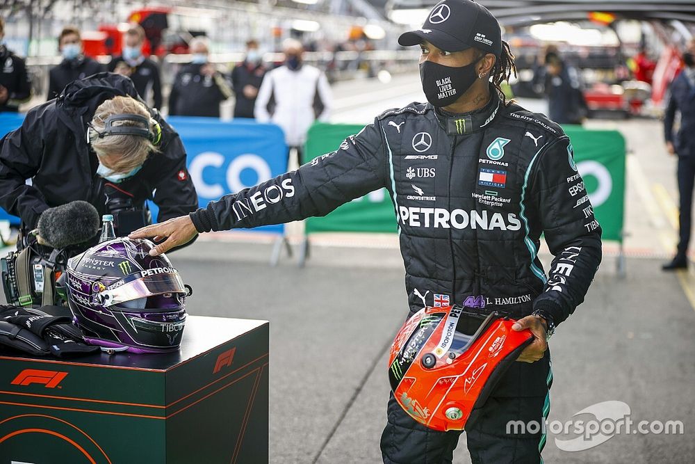 Lewis Hamilton, Mercedes-AMG Petronas F1, 1st position, on the podium with the helmet of Michael Schumacher