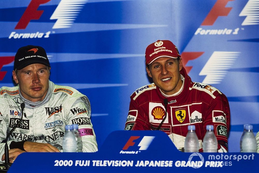 Mika Häkkinen, 2nd position, and Michael Schumacher, Ferrari F1-2000, 1st position, in the post-race Press Conference