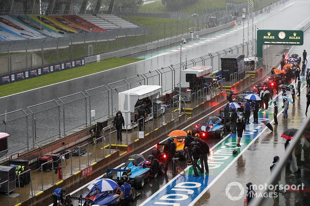 The cars in the pit lane with the session red flagged