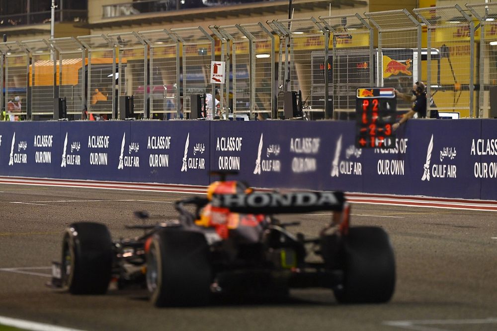 Max Verstappen, Red Bull Racing RB16B, passes his pit board