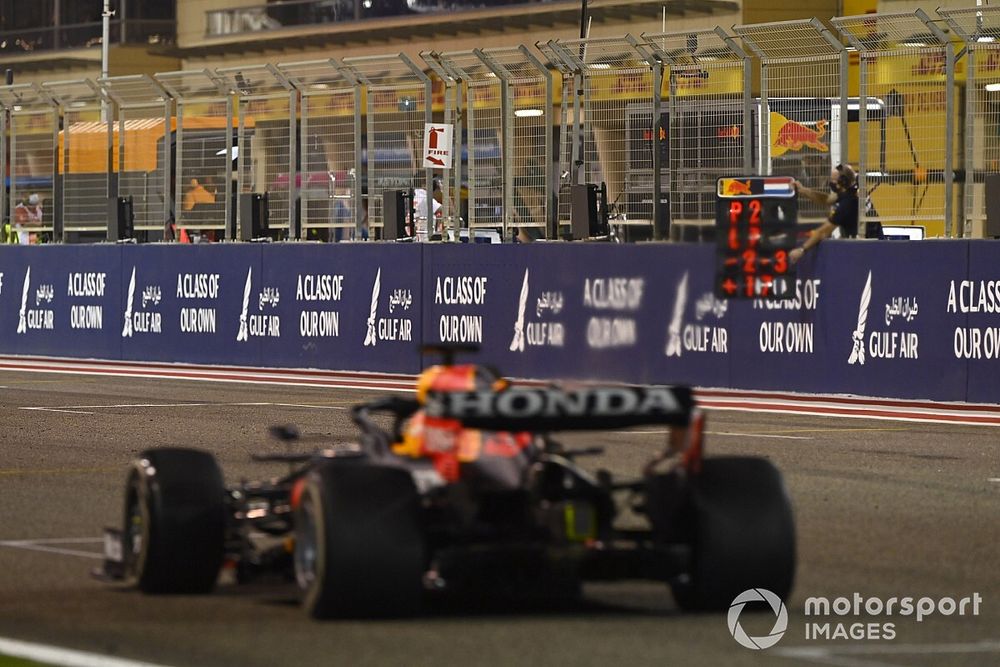 Max Verstappen, Red Bull Racing RB16B, passes his pit board