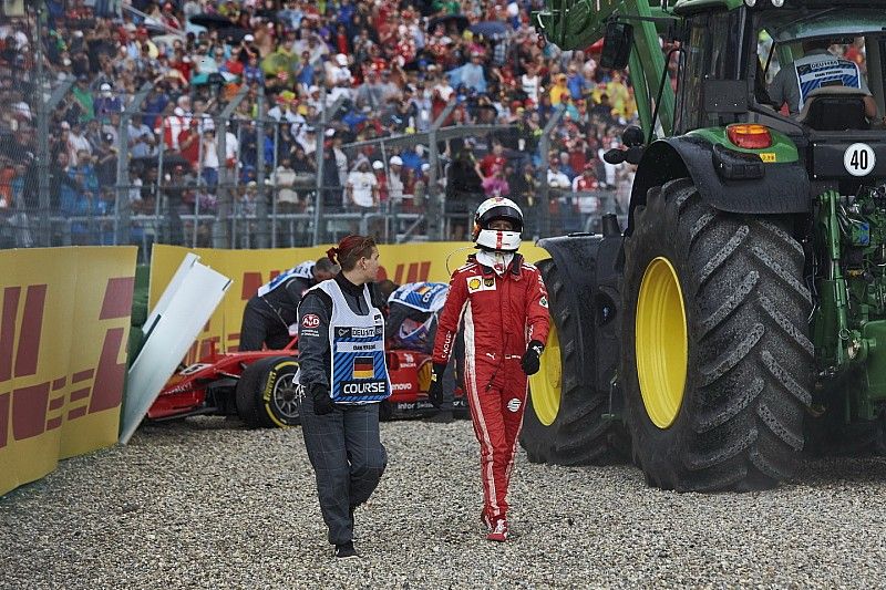 Sebastian Vettel, Ferrari SF71H, walks away from his car after crashing out from the lead