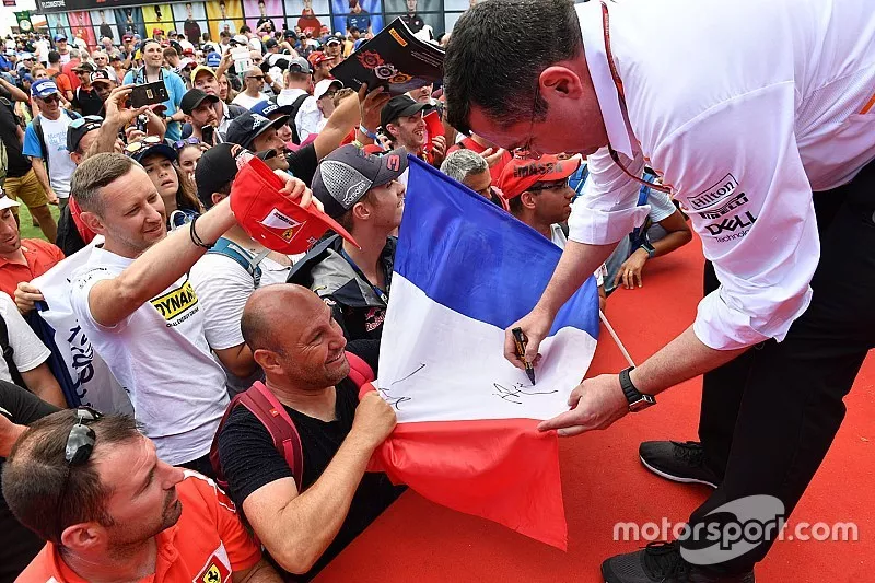 Eric Boullier, McLaren Racing Director signs autographs for the fans