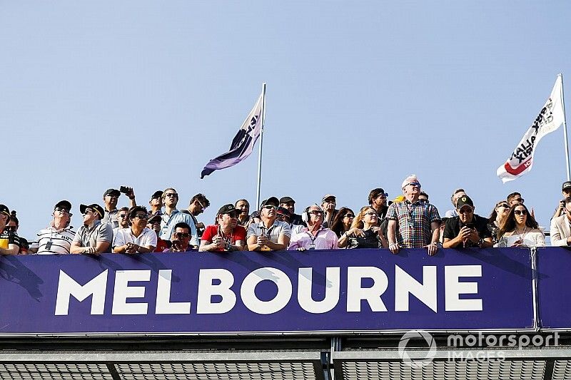 Fans watch the action from above the pit lane