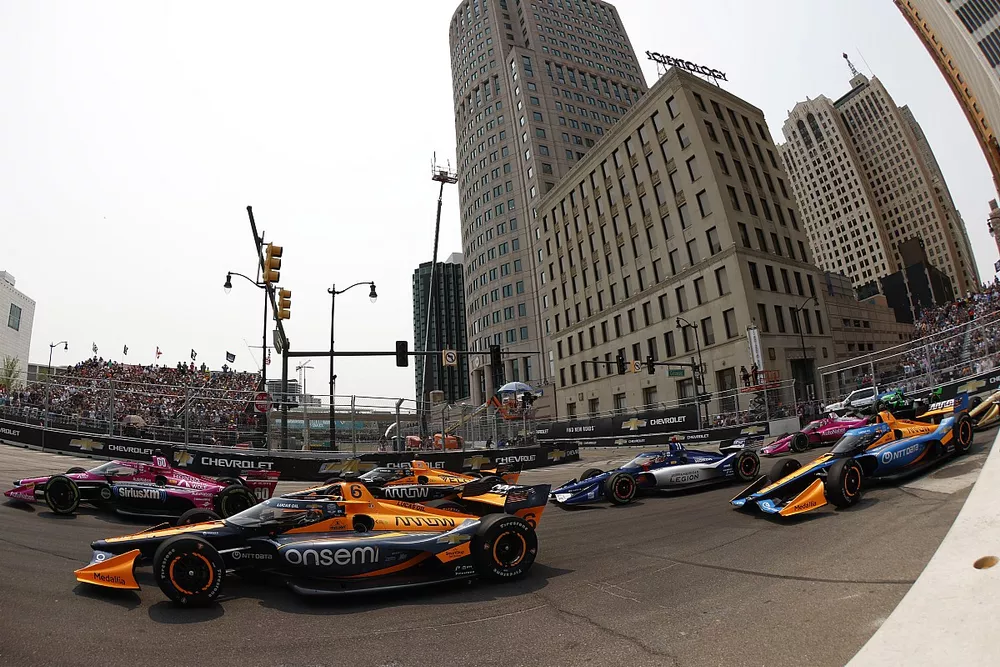 #60: Simon Pagenaud, Meyer Shank Racing Honda, #6: Felix Rosenqvist, Arrow McLaren Chevrolet, #5: Pato O'Ward, Arrow McLaren Chevrolet battle in turn one