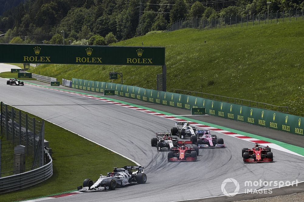 Daniil Kvyat, AlphaTauri AT01, leads as Charles Leclerc, Ferrari SF1000, and Sebastian Vettel, Ferrari SF1000, collide on the opening lap