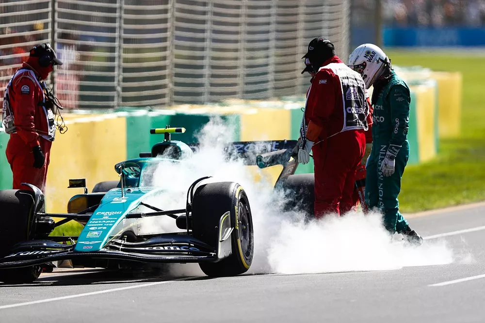 Marshals assist Sebastian Vettel, Aston Martin AMR22, after he stops during FP1