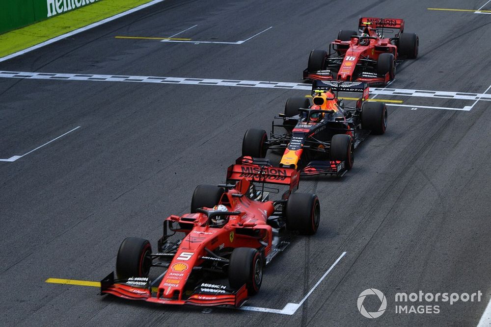 Sebastian Vettel, Ferrari SF90, leads Alexander Albon, Red Bull RB15, and Charles Leclerc, Ferrari SF90, at the end of the first Safety Car period