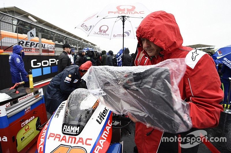 Pramac Ducati team member covers the bike