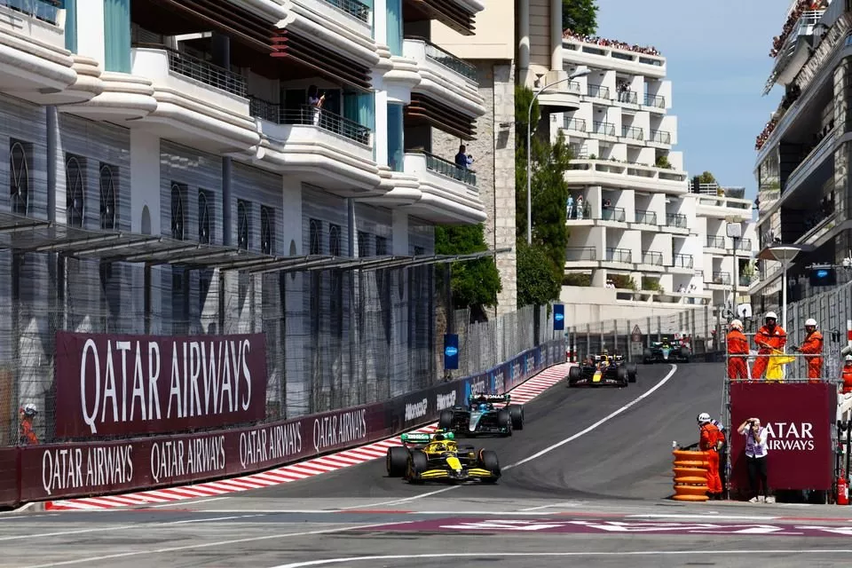 Marshals wave the yellow flags on the opening lap as Lando Norris, McLaren MCL38, George Russell, Mercedes F1 W15, Max Verstappen, Red Bull Racing RB20