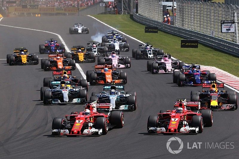 Sebastian Vettel, Ferrari SF70H, leads, Kimi Raikkonen, Ferrari SF70H at the start of the race