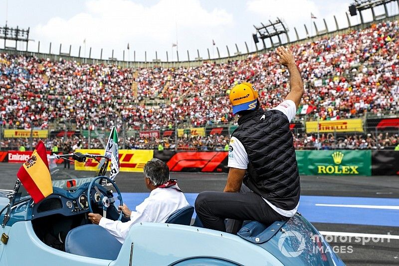 Carlos Sainz Jr, McLaren, waves to the crowd during the drivers parade