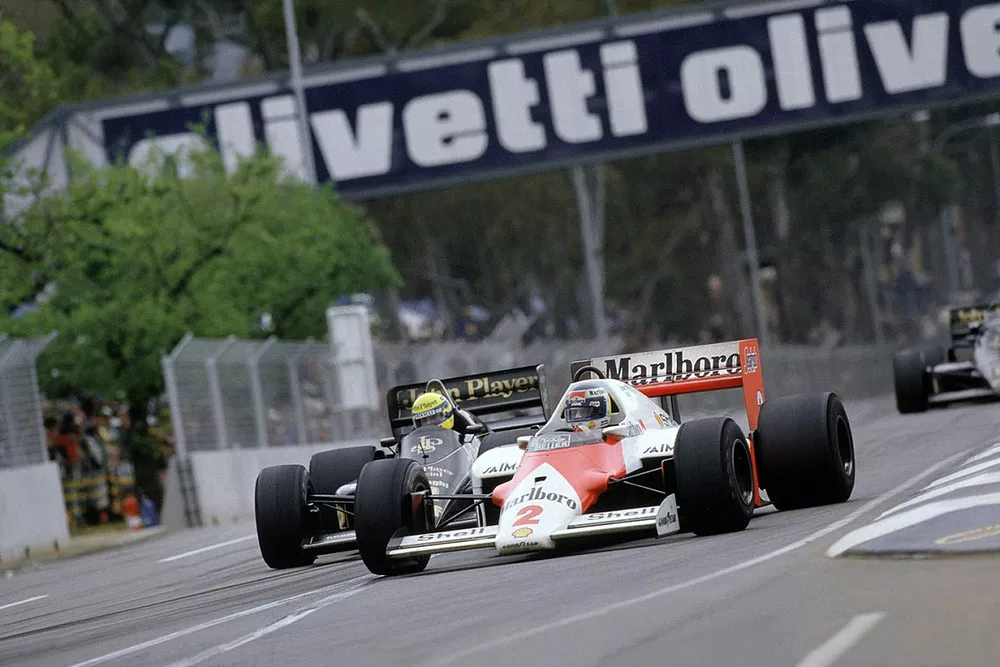 Keke Rosberg, McLaren MP4/2 TAG Porsche leads Ayrton Senna, Lotus Renault