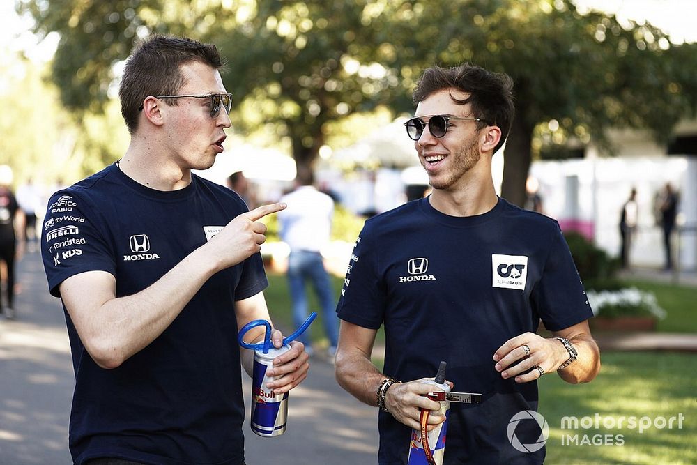 Pierre Gasly, AlphaTauri, and Daniil Kvyat, AlphaTauri AT01, in the paddock