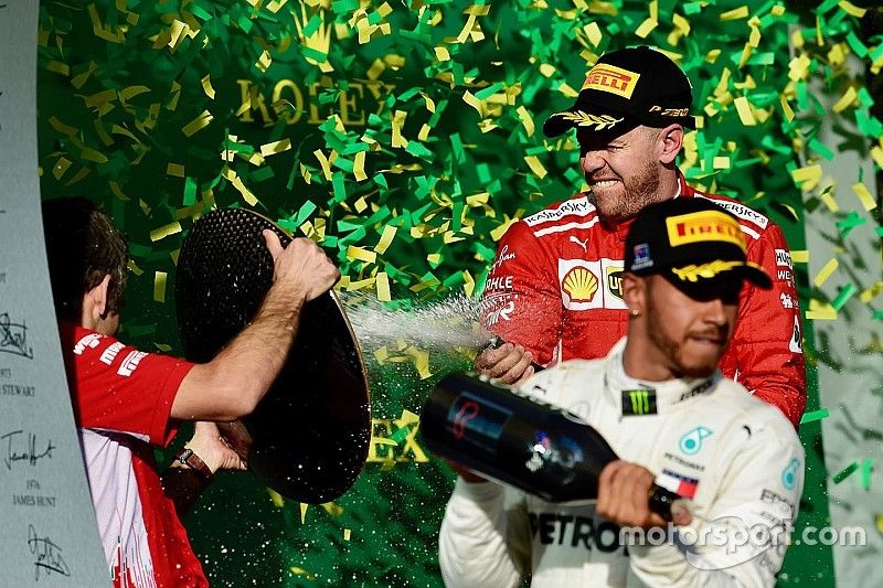 Lewis Hamilton, Mercedes-AMG F1 and Sebastian Vettel, Ferrari celebrate on the podium with the champagne