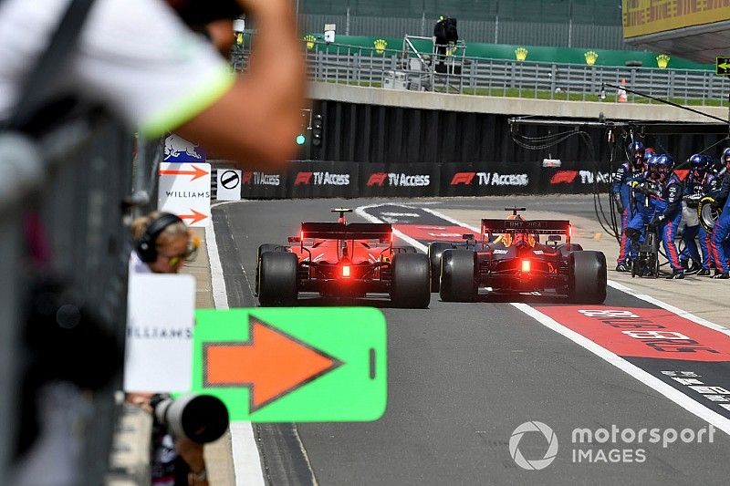 Max Verstappen, Red Bull Racing RB15, and Charles Leclerc, Ferrari SF90, race to be first out of the pit lane