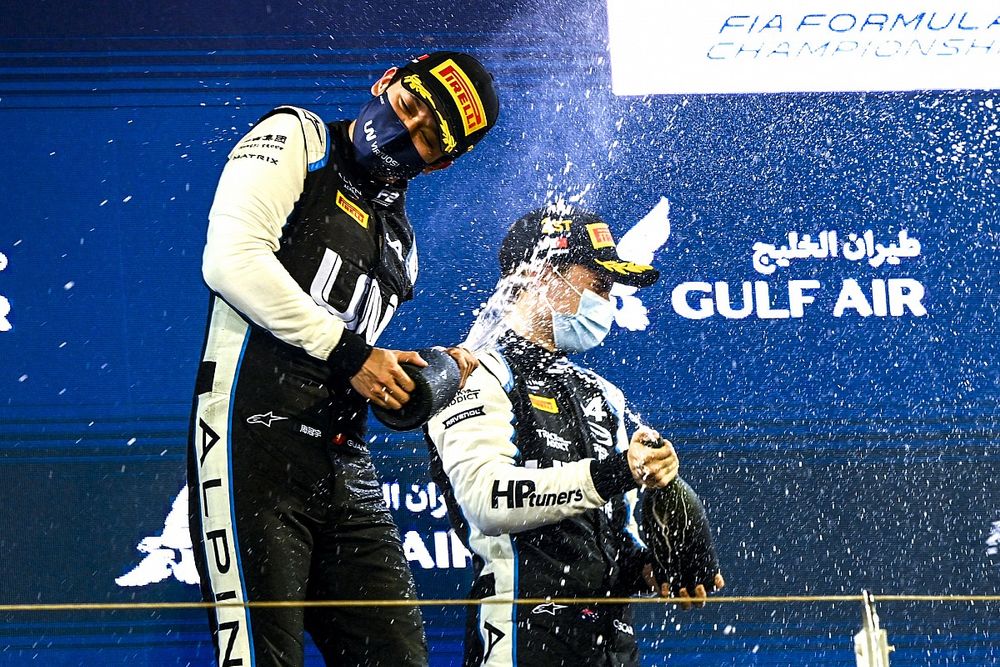 Guanyu Zhou, Uni-Virtuosi Racing, 2nd position, and Oscar Piastri, Prema Racing, 1st position, celebrate on the podium