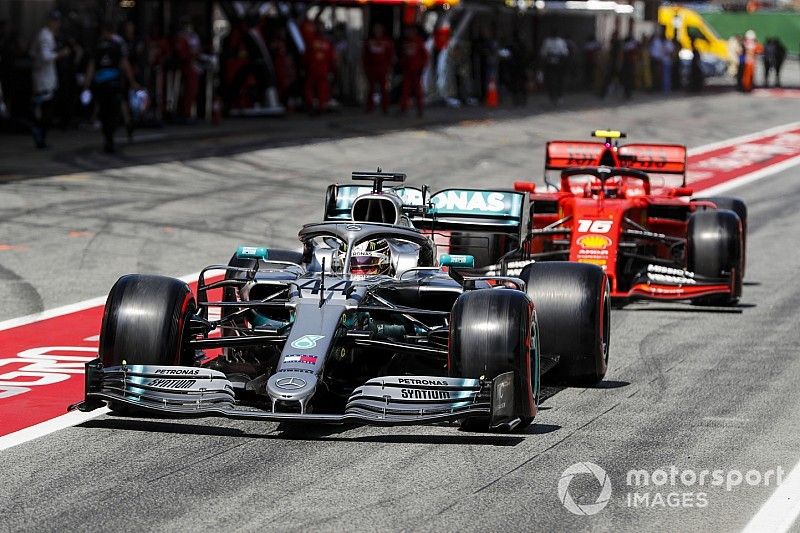 Lewis Hamilton, Mercedes AMG F1 W10, leads Charles Leclerc, Ferrari SF90, out of the pits