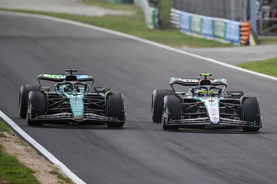 Lance Stroll, Aston Martin AMR24, battles with Lewis Hamilton, Mercedes F1 W15