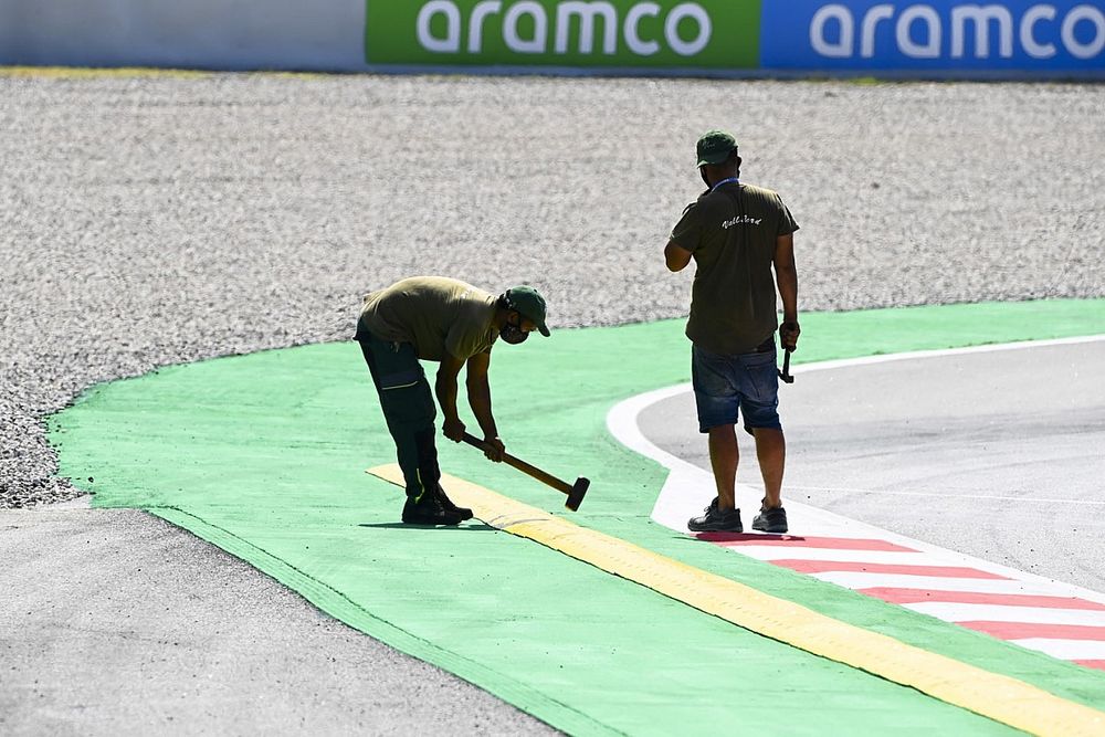 Workmen make final changes to a sausage kerb and sleeping policeman
