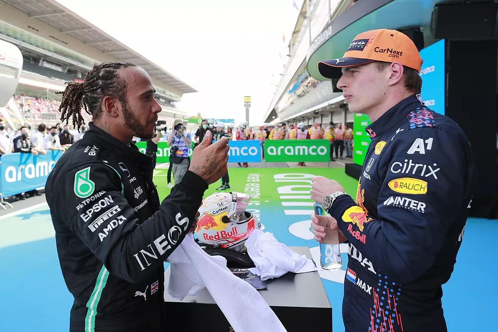 Lewis Hamilton, Mercedes, 1st position, and Max Verstappen, Red Bull Racing, 2nd position, talk in Parc Ferme