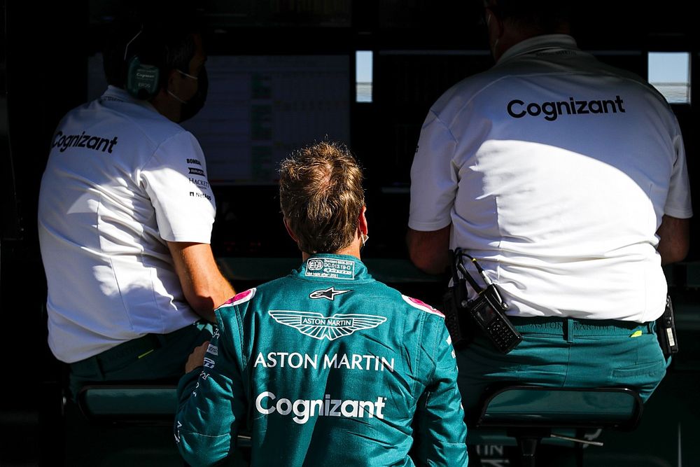 Sebastian Vettel, Aston Martin, talks to team mates on the pit wall