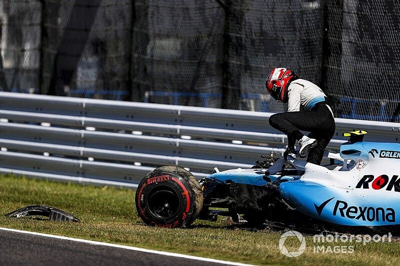 Robert Kubica, Williams Racing, climbs out of his car after crashing in Q1