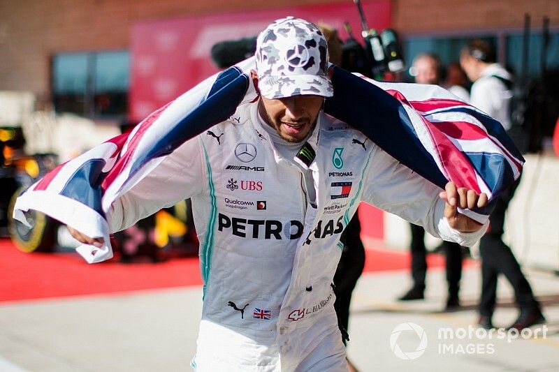 Lewis Hamilton, Mercedes AMG F1, 2nd position, celebrates with a Union flag in Parc Ferme after securing his sixth world drivers championship title