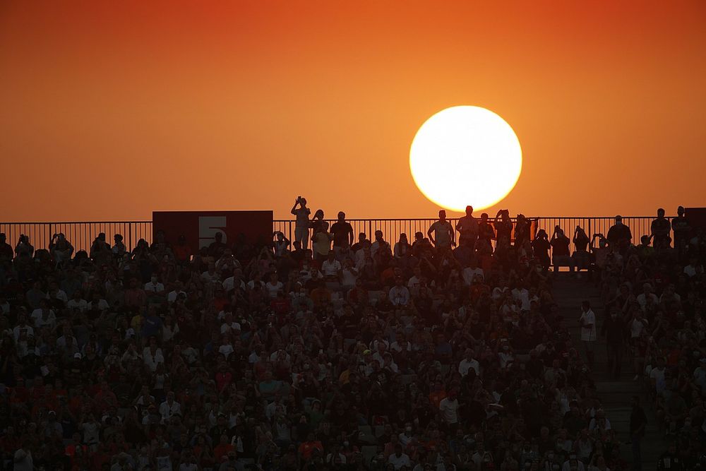 Fans fill out a grandstand as the sun sets